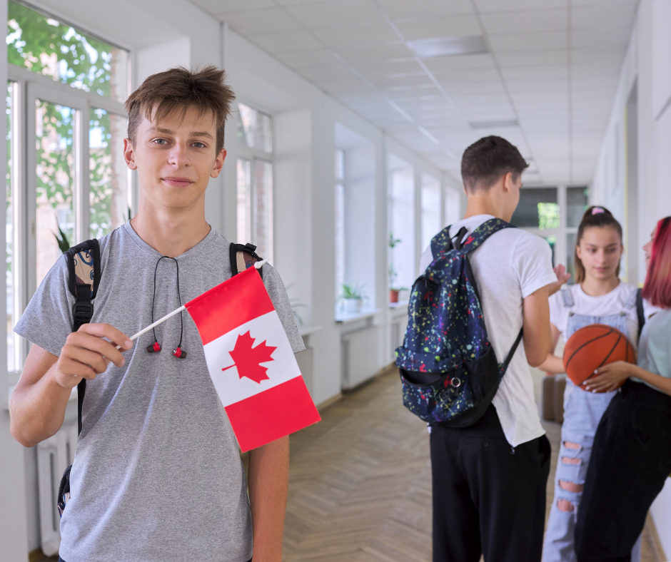 male student holding Canada flag